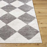 Close-up of the Arilla Diamond Checkered Washable Area Rug. Charcoal and white diamond pattern on a soft, textured rug. Front