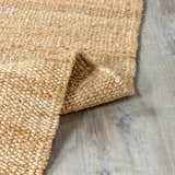 Close-up of the hand-woven Oaks Perfect Flatweave Jute Rug showing its natural beige color and textured design. Fold