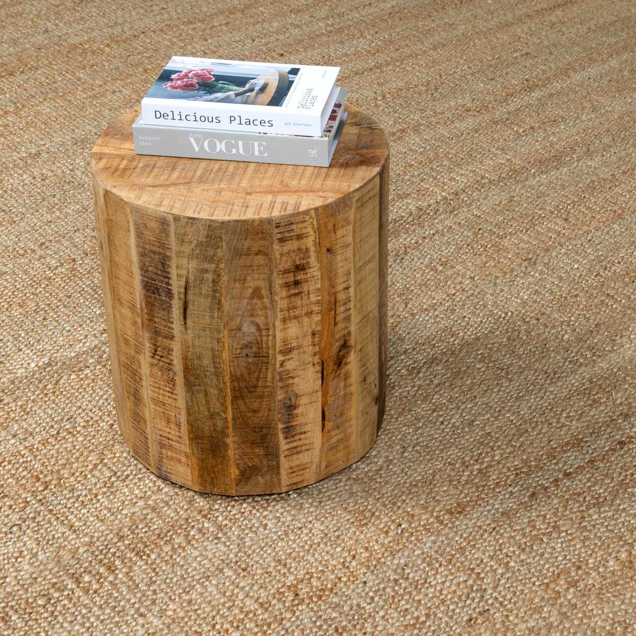 Close-up of beige Oaks Perfect Flatweave Jute Rug with natural texture. Wood accent table with books on top. Styleshot