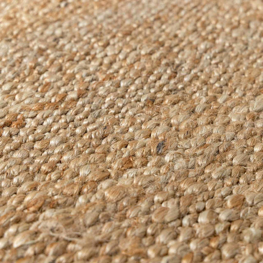 Close-up of the beige, hand-woven texture of the Oaks Perfect Flatweave Jute Rug. Natural fiber detail. Texture