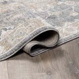 Close up of the Kanimbla Thick Luxe Avant Garde Rug showing the gray, beige, and white traditional pattern and texture. Fold