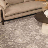 Living room scene with beige sofa and Kanimbla Thick Luxe Avant Garde Rug in gray and beige floral pattern. Styleshot