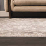 Close-up of the beige Kanimbla Thick Luxe Avant Garde Rug with a subtle traditional pattern on dark wood floors. Roomscene-Rectangle