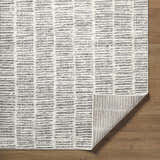 Close-up of the Aricin Gray Area Rug showing its light silver and gray horizontal stripe pattern and machine-woven texture. Fold