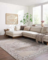 Light-filled living room with a sectional sofa and the Kailey Light Gray Area Rug with a traditional pattern. Roomscene-Rectangle