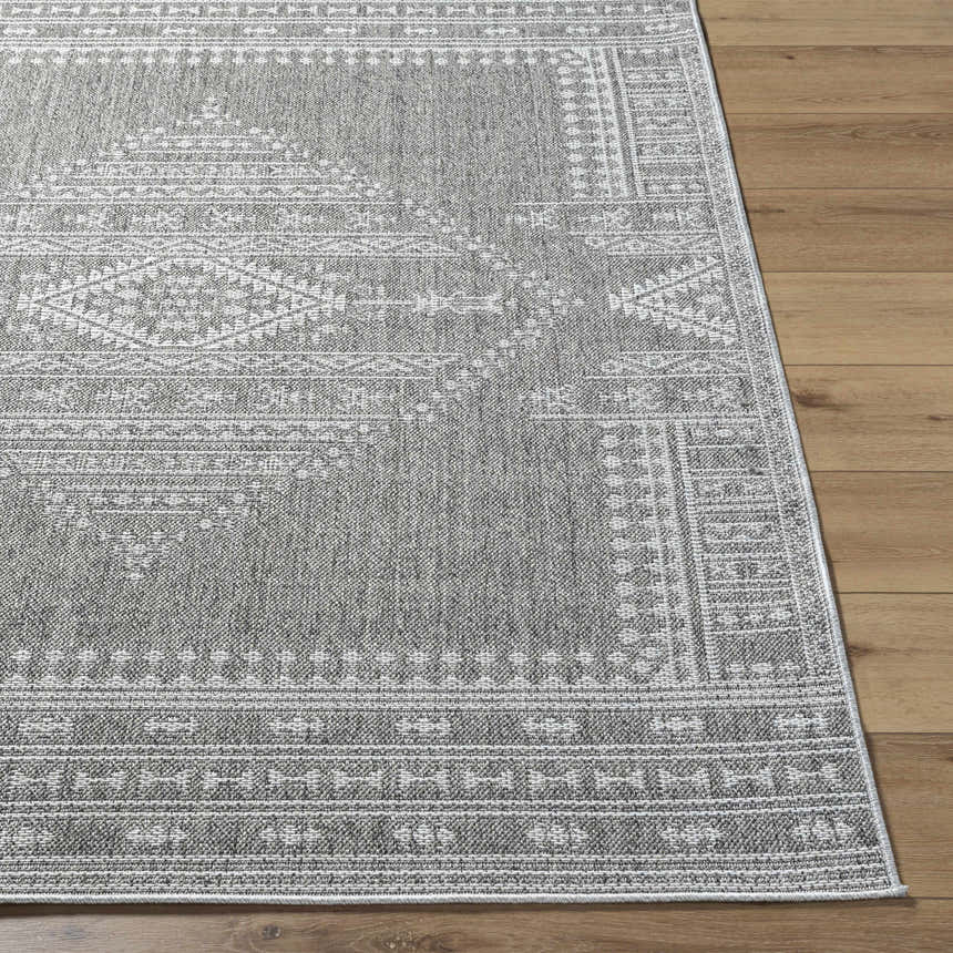 Close-up of the gray and white Asuman Area Rug, showcasing its traditional geometric pattern and woven texture. Front