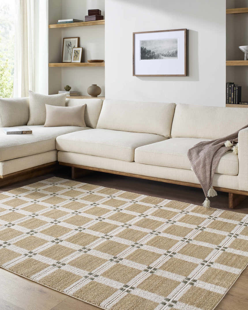 Living room with a cream sectional and Kalkin Tan Area Rug featuring a tan and white geometric pattern. Roomscene-Rectangle