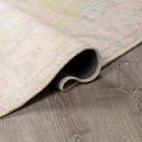 Close-up of the rolled edge of a Bozkurt Boutique Washable Rug, showing its vintage Persian pattern and polyester construction. Fold