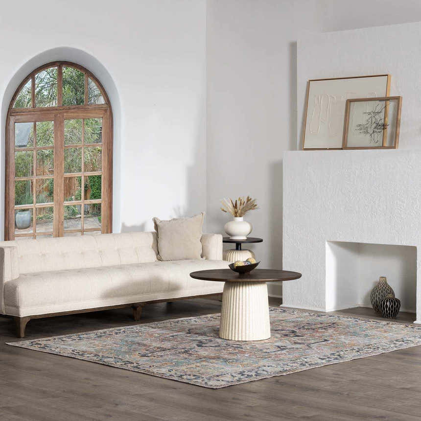 Living room with a neutral sofa and the traditional Anahawan Washable Area Rug in brick red, mustard, and navy. Roomscene-Rectangle