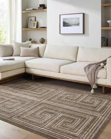 Living room scene with a neutral sectional sofa and the brown geometric Kekapa Area Rug. Roomscene-Rectangle