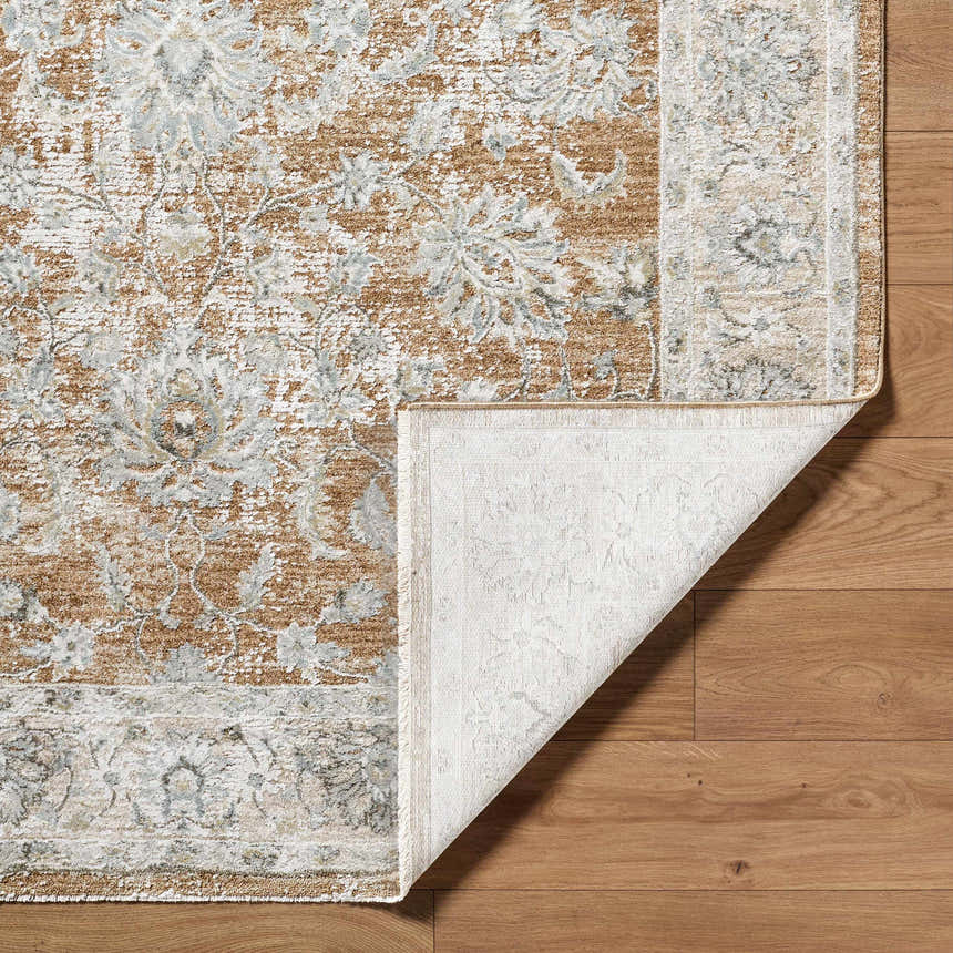 Close-up of the Kerem Damask Thick Luxe Boutique Rug showing its charcoal, cream, and light brown traditional pattern. Fold