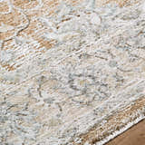 Close-up of the Kerem Damask Thick Luxe Boutique Rug. Cream, light brown, and gray damask pattern. Soft, textured weave. Texture