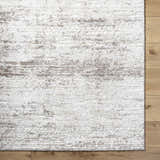 Close-up of the Kohaku Light Gray Area Rug showing its beige, ivory, and light brown traditional pattern and soft texture. Corner