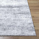 Close-up of the Kohaku Black Area Rug showing its charcoal and light gray abstract pattern and soft, textured pile. Front