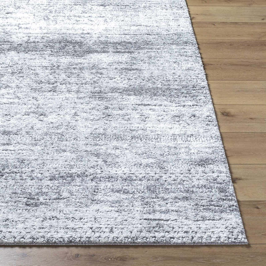 Close-up of the Kohaku Black Area Rug showing its charcoal and light gray abstract pattern and soft, textured pile. Front