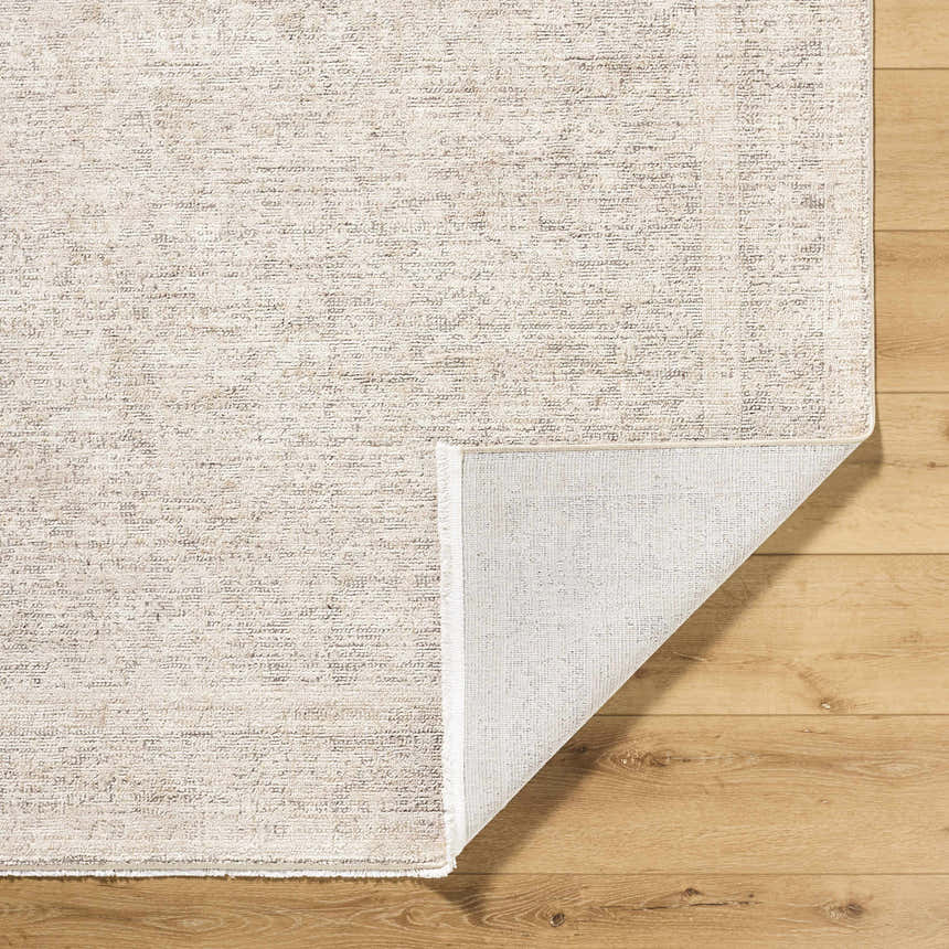 Close-up of Livabliss x Galey Alix Maria Elena V Vintage Medallion Area Rug in ivory, medium brown, and tan on wood floor. Fold