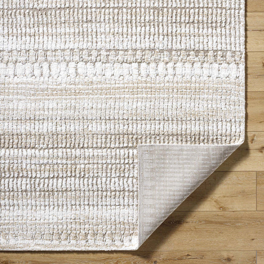 Close-up of the ash, light silver, and silver gray Akande Shag Area Rug showing the texture and machine woven construction. Fold