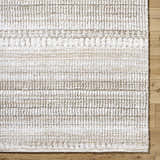 Close-up of the Akande Shag Area Rug. Ash, light silver, and silver gray shag rug with a subtle striped pattern. Corner