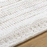 Close up of the Akande Shag Area Rug, ash, light silver, and silver gray textured shag rug. Texture