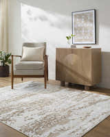 Neutral living room with a tan armchair and Arenda Tan Area Rug. Contemporary style. Roomscene-Rectangle
