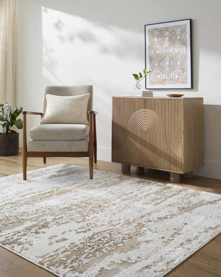 Neutral living room with a tan armchair and Arenda Tan Area Rug. Contemporary style. Roomscene-Rectangle