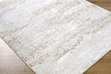 Close-up of the Arenda Tan Area Rug showing its cream and tan abstract pattern and machine-woven texture. Corner