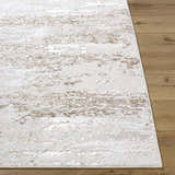 Close-up of the Arenda Tan Area Rug showing its cream and tan abstract pattern and soft texture on wood floors. Front