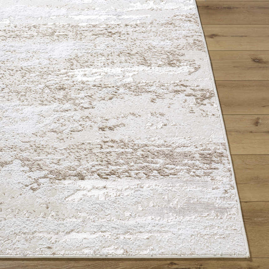 Close-up of the Arenda Tan Area Rug showing its cream and tan abstract pattern and soft texture on wood floors. Front