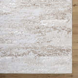 Close-up of the Arenda Tan Area Rug showing its cream and tan abstract pattern and soft, textured polyester material. Corner
