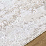 Close-up of the Arenda Tan Area Rug, showing cream and tan abstract pattern and soft texture. Texture