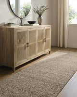 Entryway scene with a Winta Taupe Wool Area Rug, light wood floors, and a rattan console table. Neutral, transitional style. Roomscene-Runner