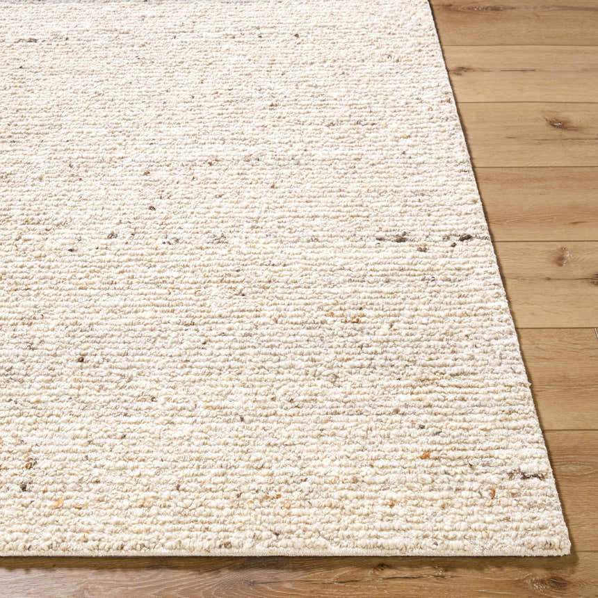 Close-up of the hand-tufted Winta Beige Wool Area Rug. Cream, ivory, and white tones with a subtle textured design. Front