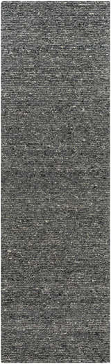 Close-up of the hand-tufted Winta Black Wool Area Rug. Gray, medium gray, and onyx tones with a subtle textured pattern. Design-Runner-310