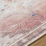 Close up of the Ussun Washable Area Rug showing beige, rust, and black traditional pattern and woven texture. Texture