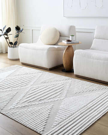 Living room with off white chairs and tan Annika Washable Area Rug with geometric pattern. Roomscene-Rectangle