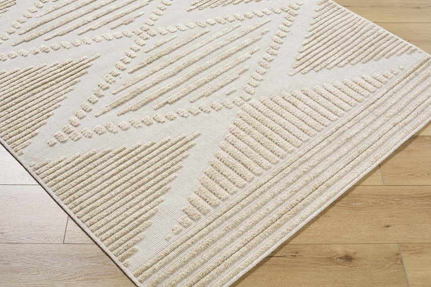 Close-up of the Annika Light Brown 3D Washable Area Rug. Features a geometric pattern with raised, textured beige lines. Corner