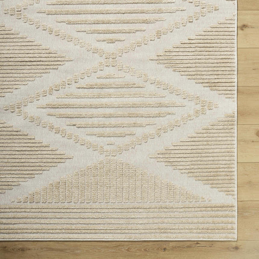 Close up of Annika Light Brown 3D Washable Area Rug. Beige and light brown rug with a geometric pattern and textured design. Corner