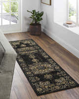 Entryway scene with a Lostwithiel Black Medallion Rug runner on wood floors, with a gray couch and natural light. Roomscene-Runner