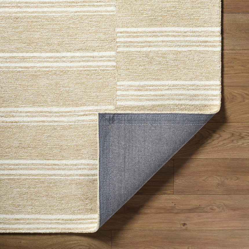 Close-up of the Argyro Area Rug showing beige, ivory, and sandstone stripes and hand-tufted wool texture. Fold