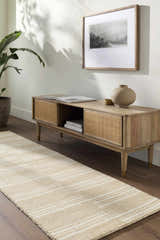 Living room scene with a beige and ivory striped Argyro Area Rug runner under a wood media console. Roomscene-Rectangle