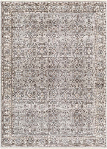 Detailed view of the Lugo Luxe Area Rug, a traditional rug with a charcoal and light gray floral pattern and tassel detail. Design-Rectangle-537