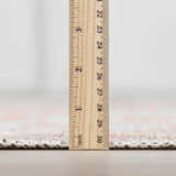 Close-up of the Rust Maayon Washable Rug pile height, showing a low profile with brick red and brown colors. Pile