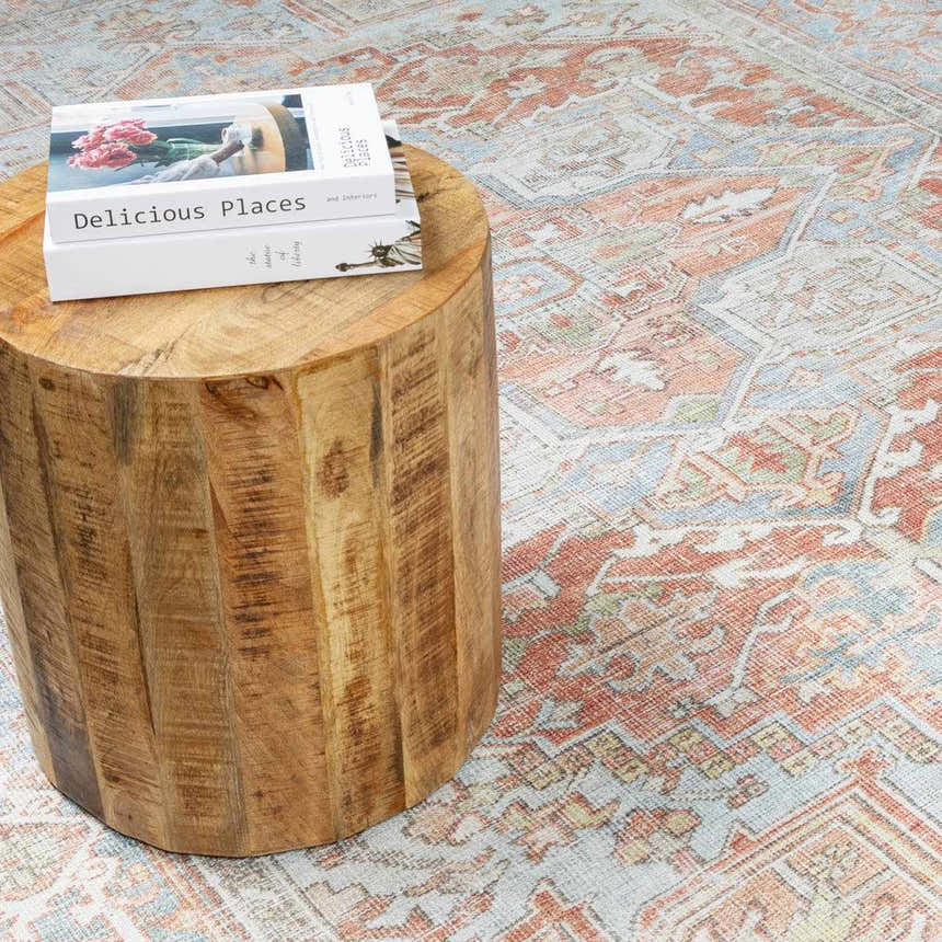 Close-up of the Rust Maayon Washable Rug featuring brick red, brown, and blue hues with a vintage Oriental pattern. Styleshot