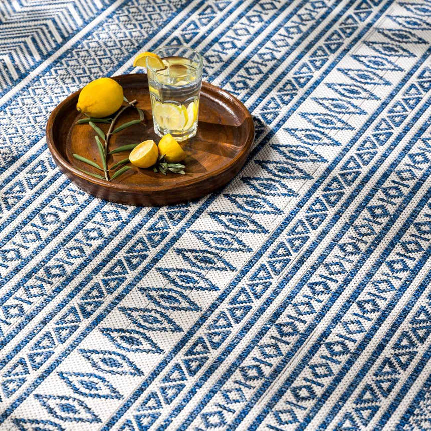 Close-up of Madras Light Blue Green All Over Performance Area Rug with a blue and white geometric pattern. Styleshot