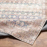 Close-up of the Maligaya Distressed Washable Rug. Bone, dark gray, and nutmeg colors in a Persian-inspired, vintage pattern. Fold