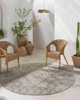 Bohemian patio with a round Marwood Nordic Performance Rug, wicker chairs, and neutral tones. Roomscene-Round