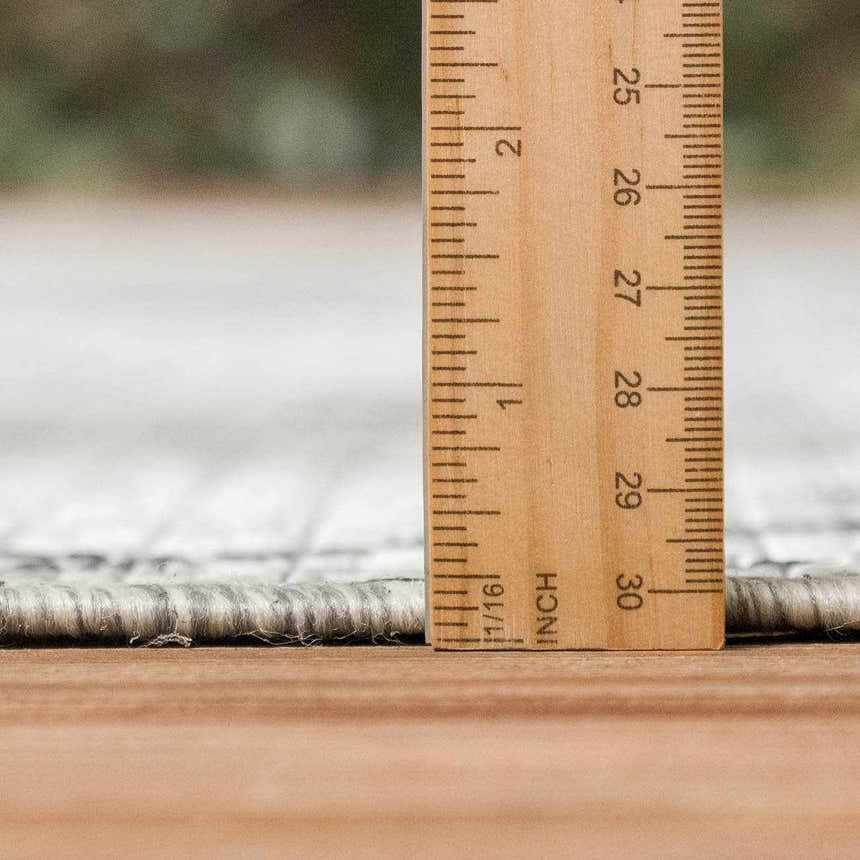 Close-up of the Marwood Nordic Performance Rug showing rug thickness with a ruler. Pile