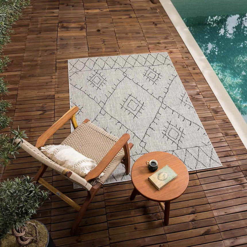 Outdoor scene with Marwood Nordic Performance Rug, chair, and side table by the pool. Roomscene-Rectangle