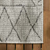 Close-up of the Marwood Nordic Performance Rug. Bohemian style, woven texture, black and white geometric pattern. Swatch
