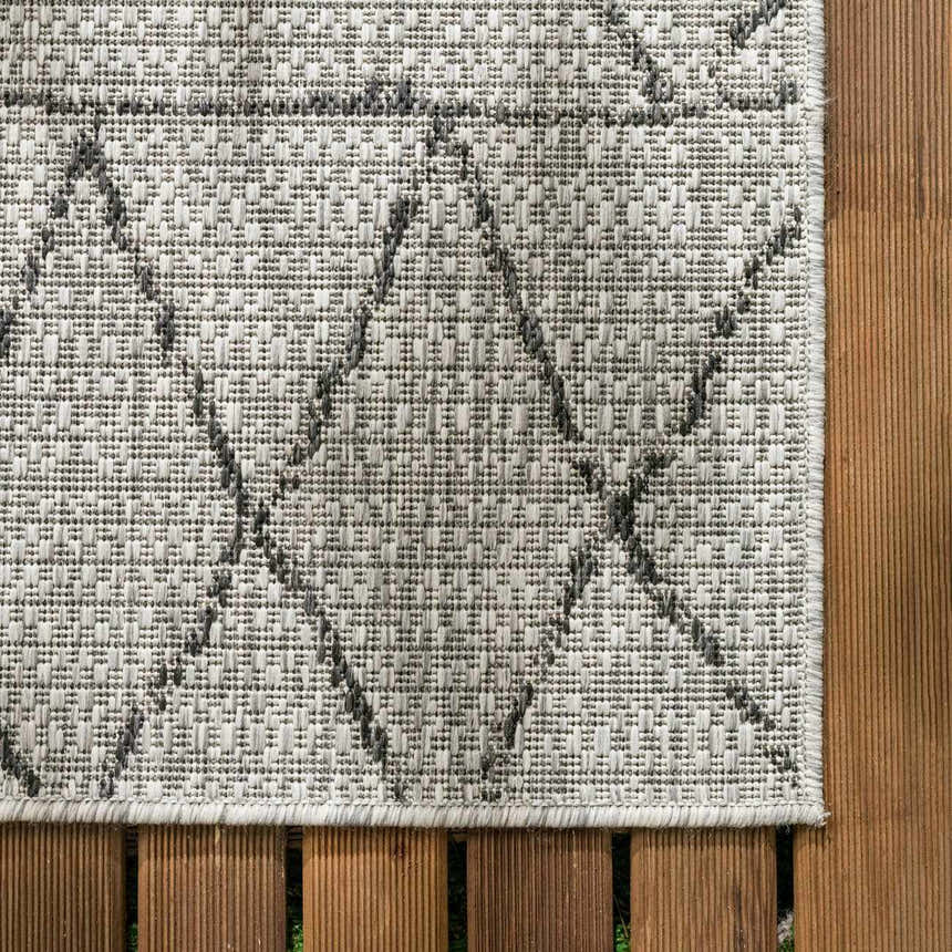 Close-up of the Marwood Nordic Performance Rug. Bohemian style, woven texture, black and white geometric pattern. Swatch